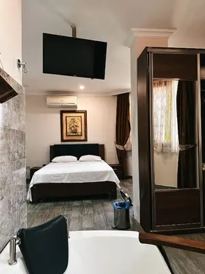 a hotel room with a bed and a bath tub at Beach Butik Hotel Şile in Istanbul