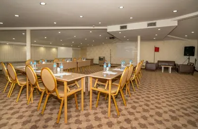 a conference room with tables and chairs and a podium at The Bostancı Otel in Istanbul