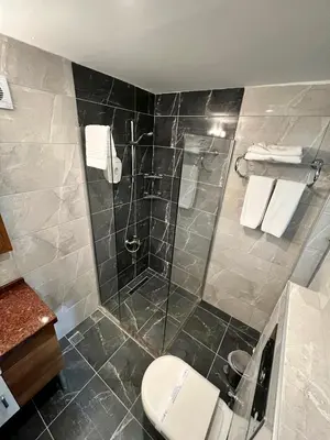 a bathroom with a shower and a toilet at The Bostancı Otel in Istanbul