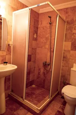 a shower in a bathroom with a toilet and a sink at Ağva Carpediem Otel in Agva