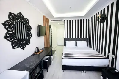 a bedroom with a bed and a black and white striped wall at Cnr İnci Hotel in Istanbul