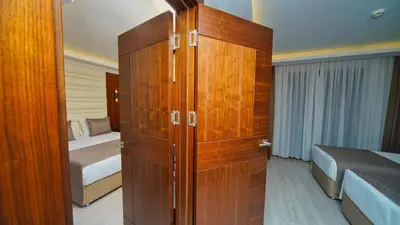 a large wooden cabinet in a bedroom with two beds at My Dream Istanbul Hotel in Istanbul