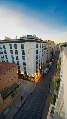 a large white building on a city street with buildings at My Dream Istanbul Hotel in Istanbul