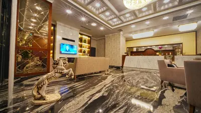 a lobby with a table and chairs and a television at My Dream Istanbul Hotel in Istanbul