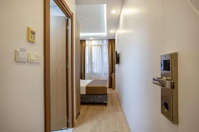 a hallway with a door and a bed in a room at West Palace in Istanbul