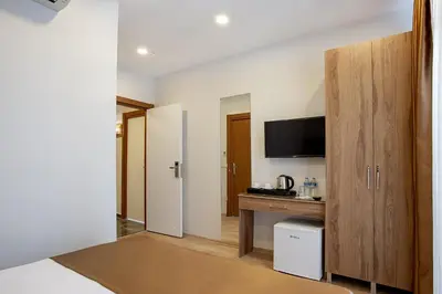 a hotel room with a desk and a tv at West Palace in Istanbul