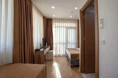 a hotel room with two beds and a window at West Palace in Istanbul