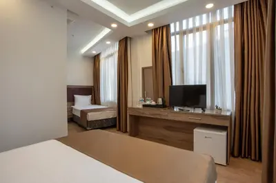a hotel room with a bed and a television at West Palace in Istanbul