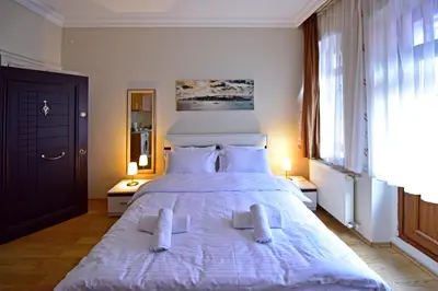 a bedroom with a large white bed with two pillows at Sunshine Taksim Suite in Istanbul
