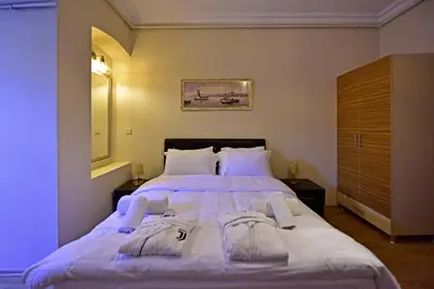 a bedroom with a large bed with towels on it at Sunshine Taksim Suite in Istanbul