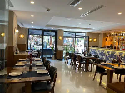 a restaurant with wooden tables and chairs and a bar at Suadhan Hotel in Istanbul