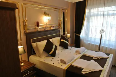 a bedroom with a bed with pillows and a window at Emirhan Guesthouse & Suites in Istanbul