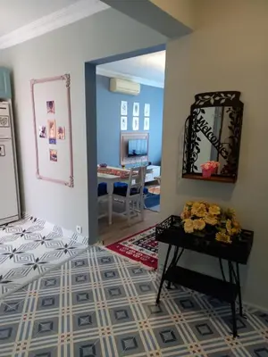 a room with a bed and a table with a mirror at Emirhan Guesthouse & Suites in Istanbul