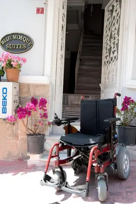 a wheelchair parked outside of a building with flowers at Blue Mosque Suites 2 - Old City Sultanahmet in Istanbul