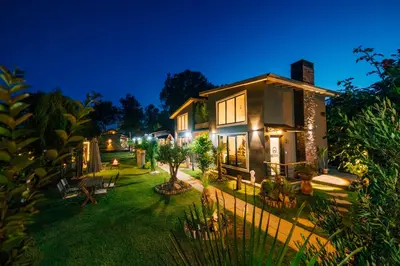 a house with a garden at night at antik river house in Sile