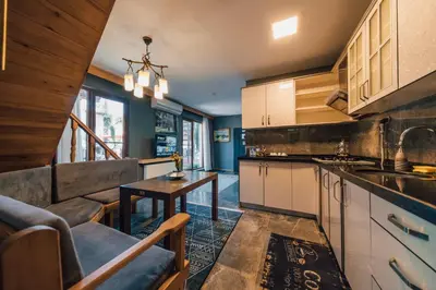 a kitchen with a couch and a table in a room at antik river house in Sile