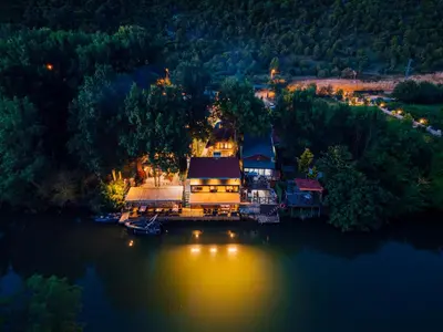 an aerial view of a house on the water at night at antik river house in Sile