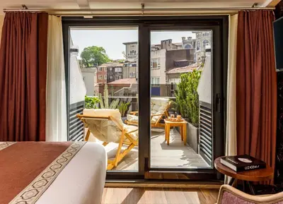 a room with a bed and a balcony with a view at Euro Design Hotel in Istanbul