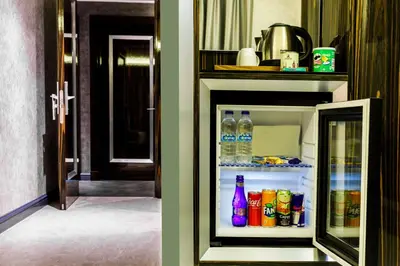 an open refrigerator with bottles of water and soda at Euro Design Hotel in Istanbul