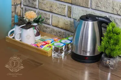 a coffee maker sitting on a counter next to a tray at İstanbul Terrace Hotel in Istanbul