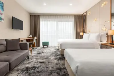 a hotel room with two beds and a couch at Tryp by Wyndham Istanbul Topkapi in Istanbul