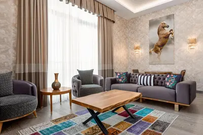 a living room with a couch and chairs and a table at Tryp by Wyndham Istanbul Topkapi in Istanbul