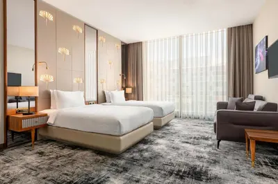 a hotel room with two beds and a couch at Tryp by Wyndham Istanbul Topkapi in Istanbul