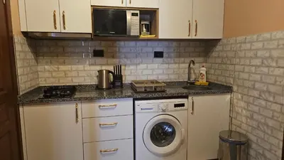 a kitchen with a washing machine and a microwave at The Pashas House in Istanbul