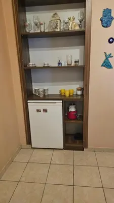 a small kitchen with a white refrigerator and shelves at The Pashas House in Istanbul