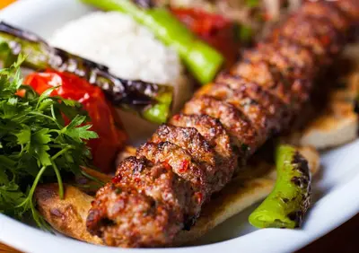 a white plate of food with meat and vegetables at The Pashas House in Istanbul