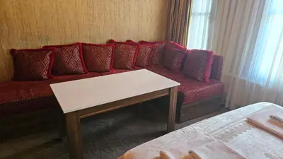 a living room with a red couch and a table at The Pashas House in Istanbul