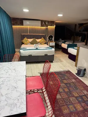 a bedroom with a bed and two chairs and a table at Galaxy Hotel Sultanahmet in Istanbul