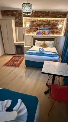 a bedroom with a large bed and a brick wall at Galaxy Hotel Sultanahmet in Istanbul