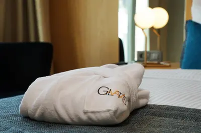 a white pillow sitting on a bed in a hotel room at Galata's Hotel in Istanbul
