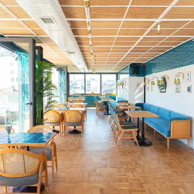 a restaurant with tables and chairs and windows at Galata's Hotel in Istanbul