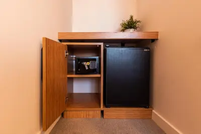 a small kitchen with a black refrigerator in a room at Bram Hotel Istanbul in Istanbul