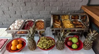 a table topped with plates of food and bowls of fruit at Bram Hotel Istanbul in Istanbul