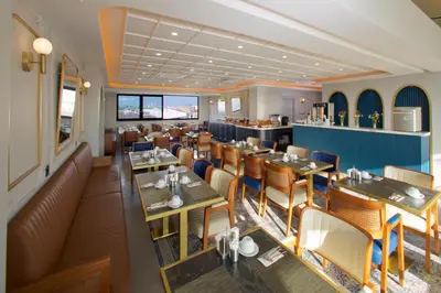 a restaurant with tables and chairs and a bar at New Florenta Hotel in Istanbul