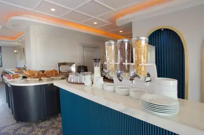a kitchen with a counter with plates and food on it at New Florenta Hotel in Istanbul