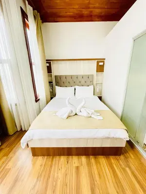 a bedroom with a bed with a bow on it at QONAQ HOTEL & SUITES in Istanbul
