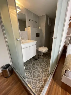 a bathroom with a sink and a toilet at QONAQ HOTEL & SUITES in Istanbul