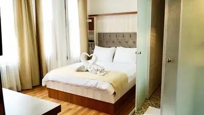 a bedroom with a bed with two swans on it at QONAQ HOTEL & SUITES in Istanbul