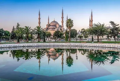 a mosque with its reflection in a pool of water at QONAQ HOTEL & SUITES in Istanbul