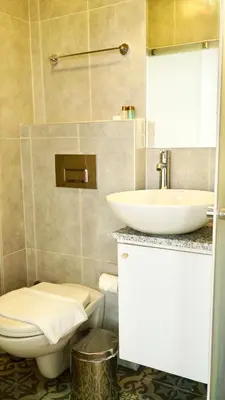 a bathroom with a toilet and a sink at QONAQ HOTEL & SUITES in Istanbul