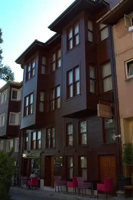 a building with red chairs in front of it at QONAQ HOTEL & SUITES in Istanbul
