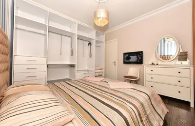 a bedroom with a bed and a dresser and a mirror at İskete Suit in Istanbul