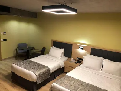 a hotel room with two beds and a table at Red Stone Hotel in Istanbul