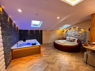 a bedroom with a large bed and a tub at Gumus Palace Hotel in Istanbul