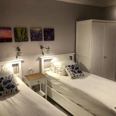 a bedroom with two twin beds and a cabinet at Mehmet Bey Suites in Istanbul