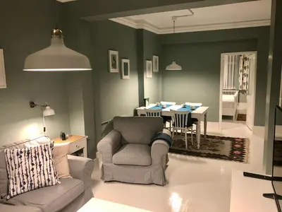 a living room with a chair and a table at Mehmet Bey Suites in Istanbul